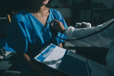 healthy concept; Doctor checking patient's heart with stethoscope at a hospital