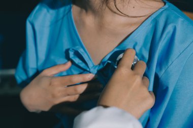 healthy concept; Doctor checking patient's heart with stethoscope at a hospital