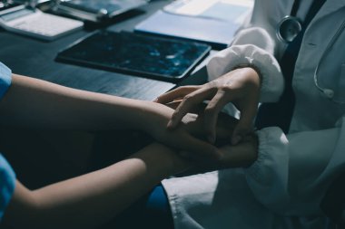 Male doctors shake hands with patients encouraging each other and praying for blessings. To offer love, concern, and encouragement while checking the patient's health. concept of medicine