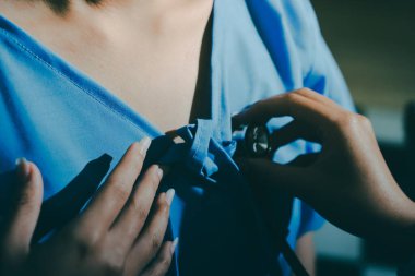 healthy concept; Doctor checking patient's heart with stethoscope at a hospital