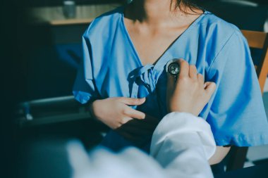healthy concept; Doctor checking patient's heart with stethoscope at a hospital