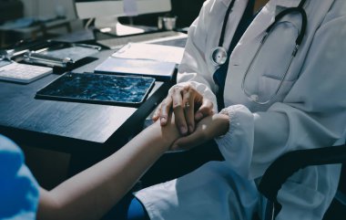Male doctors shake hands with patients encouraging each other and praying for blessings. To offer love, concern, and encouragement while checking the patient's health. concept of medicine