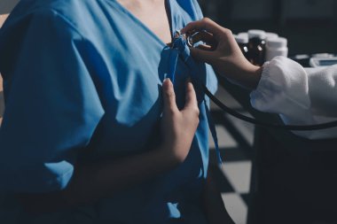 healthy concept; Doctor checking patient's heart with stethoscope at a hospital