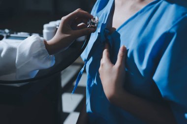 healthy concept; Doctor checking patient's heart with stethoscope at a hospital