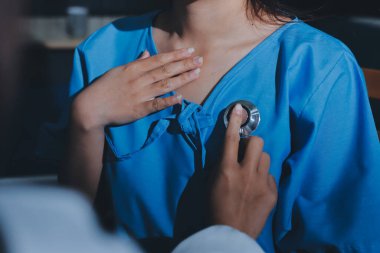healthy concept; Doctor checking patient's heart with stethoscope at a hospital