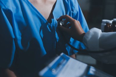 healthy concept; Doctor checking patient's heart with stethoscope at a hospital
