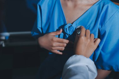 healthy concept; Doctor checking patient's heart with stethoscope at a hospital