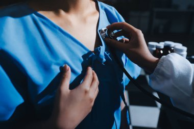healthy concept; Doctor checking patient's heart with stethoscope at a hospital