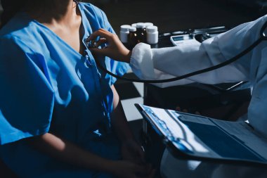 healthy concept; Doctor checking patient's heart with stethoscope at a hospital
