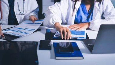 Tıbbi ekip toplantısı, brifing sırasında not alan doktorlar.