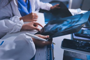 Tıbbi ekip toplantısı, brifing sırasında not alan doktorlar.