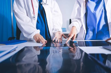 Tıbbi ekip toplantısı, brifing sırasında not alan doktorlar.