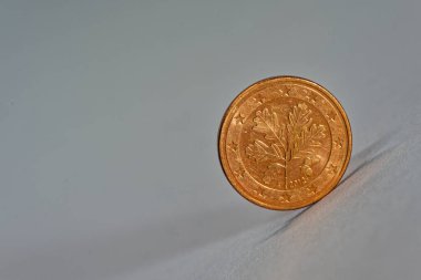 Temiz bir yüzeyde dimdik duran tek bir avro sent 'in minimalist görüntüsü. Finansman için mükemmel basitlik değeri para temel ve modern tasarım düzeni.