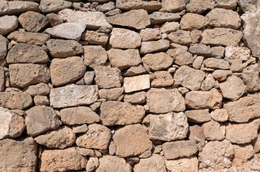 Düzensiz desenli taşlı, taştan bir duvara yakın plan.