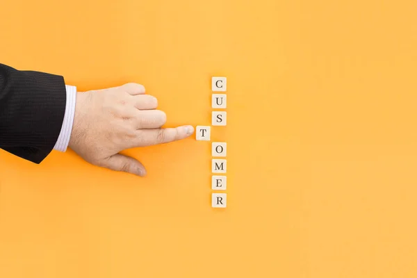 The inscription Customer made from cubes. Conceptual image for an article or review about customers.