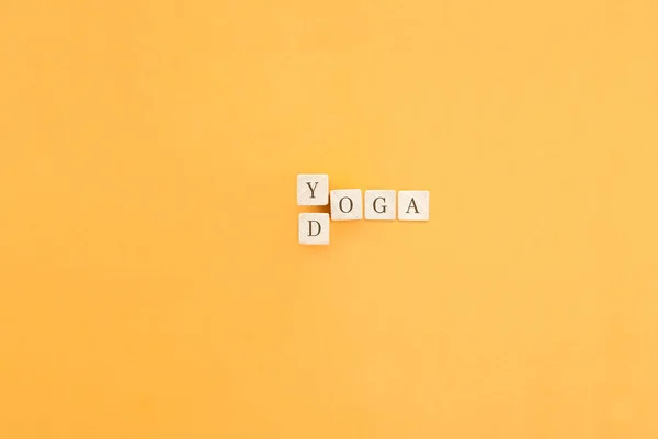 Changing the word made up of cubes with letters, turning Yoga word into Doga. The concept of choosing to practice yoga with a dog.