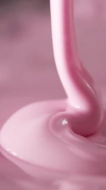 Kalın, pembe bir madde yavaşça akar, düzgün kıvrımlar ve şekiller oluşturur. Odak noktası sıvının büyüleyici hareketi ve dokusunun zarifçe kıvrılmaya devam etmesi..