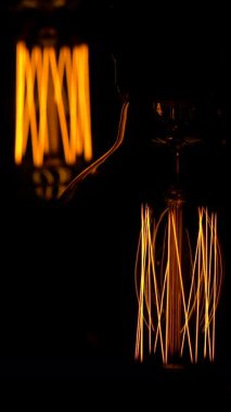 Kaliteli ampullerin parlak ve karmaşık tasarımları loş bir ortamda sıcacık ve davetkar bir atmosfer yaratarak parıldıyor. Benzersiz şekiller dekoru güzelleştiriyor..