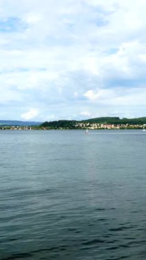 Sakin Constance Gölü Bulutlu Gök Altında Su, Uzak Köy ve Yeşil Tepeler, Yumuşak Dalgalar