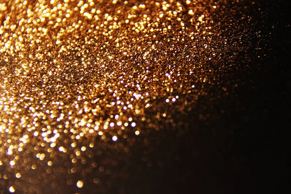 Gold sequins. Christmas, holiday background. Sparkles of golden plate texture background.