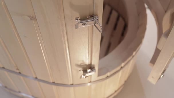 Cedar phytobarrel with wooden door,handle inside with grate for sitting closeup — Stock Video