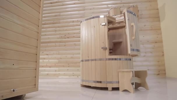 Un phyto-barril de cedro medio abierto con taburete al lado en una habitación del salón de spa — Vídeo de stock