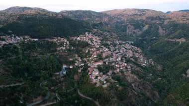 Uzak insansız hava aracı görüntüsü, Yunanistan 'da geleneksel taş evleri ve kırmızı kiremitli çatıları olan dik yamaçlara amfiteatral olarak inşa edilmiş bir köy olan Lagkadia' yı ortaya çıkardı.