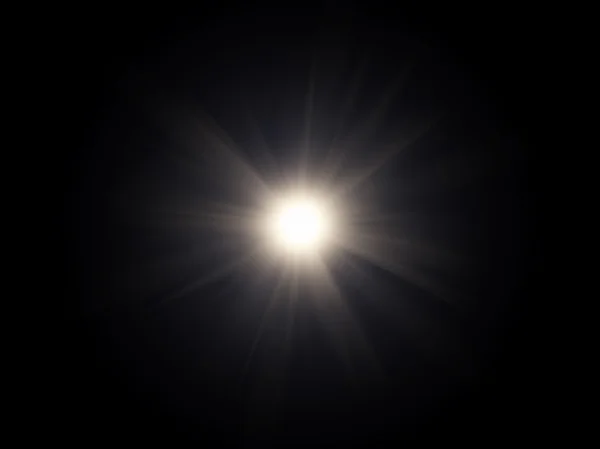 Weißlicht-Spezialeffekt vor dunklem Hintergrund. — Stockfoto