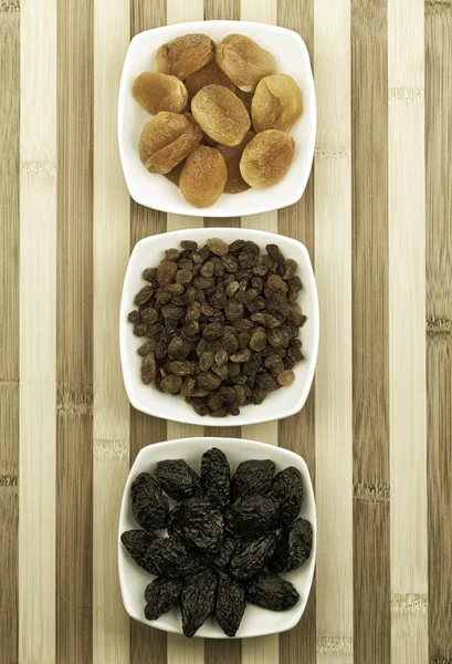 dried fruits in white dishes