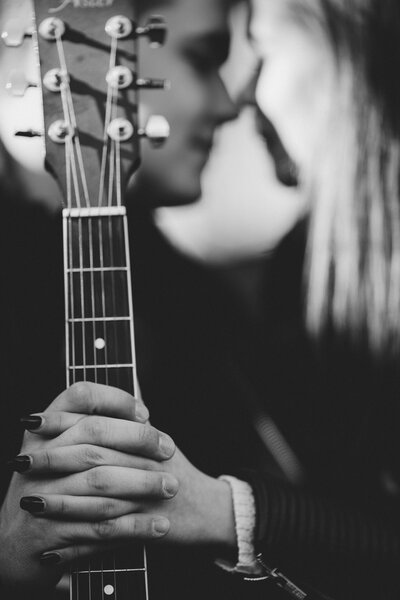 young couple holding fretboard