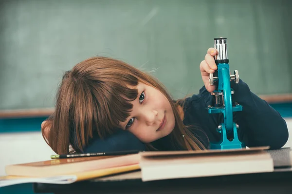 Schoolgirl laid head on her hand — Stock Photo, Image