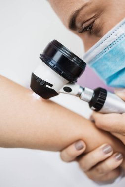 Close up shot of modern dermatology skin check up with digital deramatoscope. Dermoscopy microscope procedure and skin cancer prevention treatment.  clipart