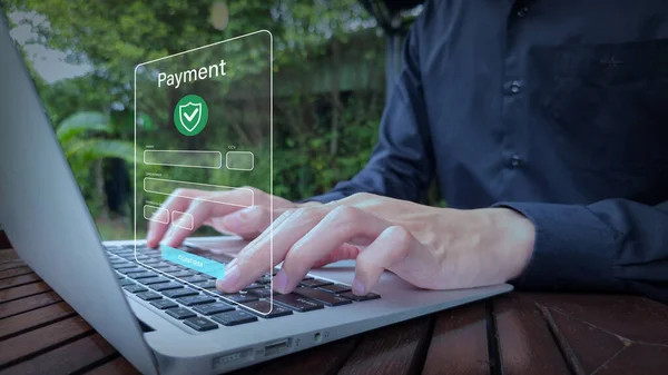 Outdoor laptop user with secure online payment interface and confirm button