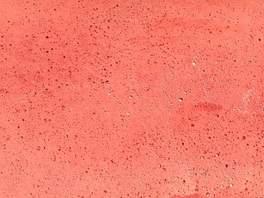 Gözenekli yüzeyi ve doğal kaba yapısı olan mercan pembesi desenli beton zemin. Modern grafik tasarım, markalaşma ve reklam tasarımları için kopya alanı olan canlı monokrom duvar dokusu.