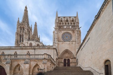 Santa Maria 'nın İkonik Burgos Katedrali etkileyici Gotik mimarisini gözler önüne seriyor, detaylı gül penceresi, karmaşık kuleler, ve tarihi taş cephe, keşif ve hayranlık uyandırıcı