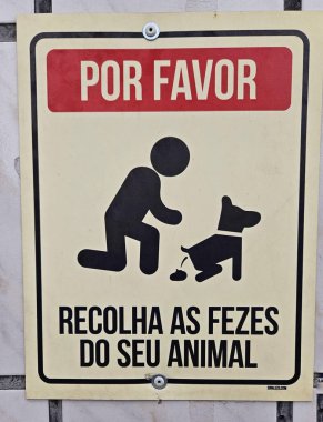 Sahiplerinden evcil hayvan atıklarını toplamalarını isteyin. Görüntü, köpek tarafından çömelmiş, sahiplerinin kamu temizliği ve toplum sağlığı görevlerini vurgulayan kişinin simgesini gösteriyor.