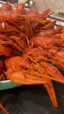 Close-up of freshly boiled red crayfish served on a plate. Delicious seafood dish, traditional cuisine, concept of gourmet meal, restaurant food and beer snack. High quality photo