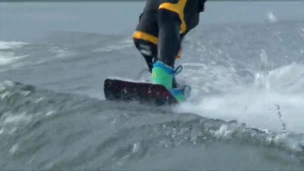 Nära upp skott wakeboarder stövlar och styrelsen — Stockvideo