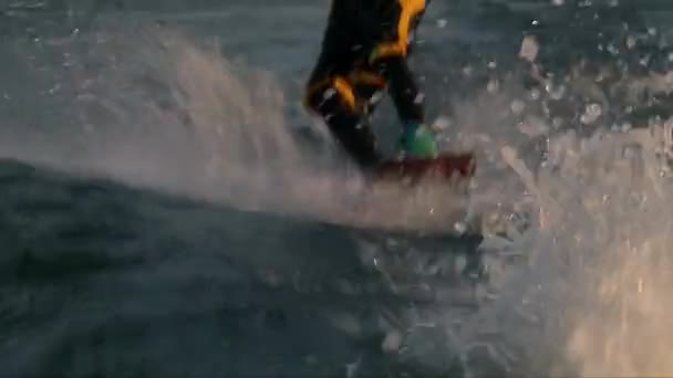 Close up shot of wakeboarder man boots and wake board — Stock Video