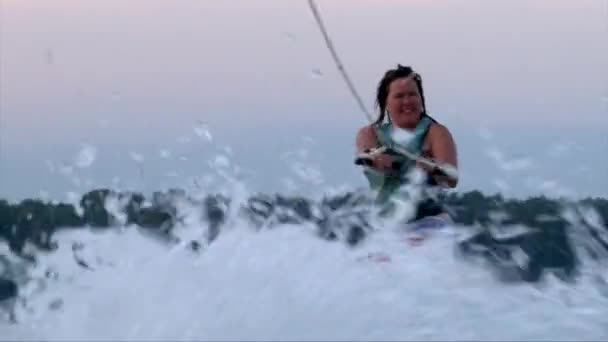 Close up shot of smiley happy wakeboarder girl going under water — Stock Video