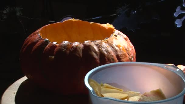 Sequence scooping flesh and seeds from Halloween Pumpkin — Stock Video
