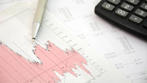 Accounting concept. Pen and calculator on a calculation background