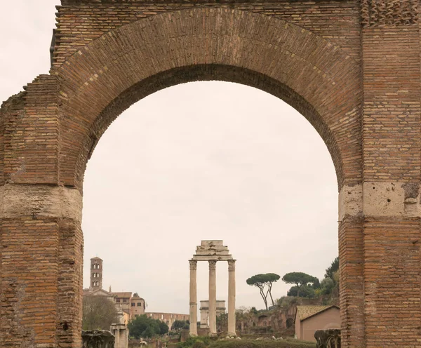 Roman Forum ruins view through the arch in Rome, Italy. Italian ancient buildings and famous landmarks