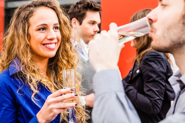 Young people drinking wine in restaurant — Stock Photo, Image