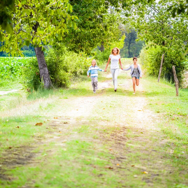 Donna con bambini che trascorrono del tempo in giardino — Foto Stock