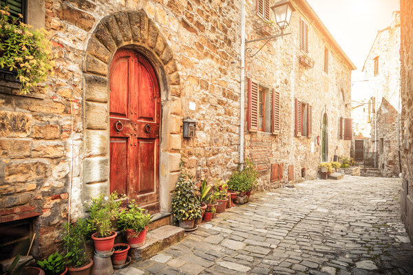Narrow old street with ancient buildings in Montefioralle village, Tuscany, Italy