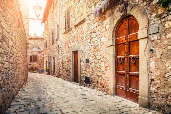 Narrow old street with ancient buildings in Montefioralle village, Tuscany, Italy
