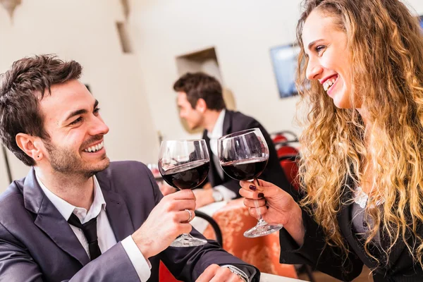 Casal sorridente bebendo vinho no restaurante — Fotografia de Stock