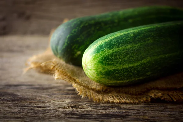 Fresh cucumber on rustic wooden background. Cucumbers are low in calories but high in many important vitamins and minerals that could potentially help you lose weight.