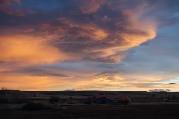 Beautiful sky at sunset dark blue and bright orange clouds over the highway